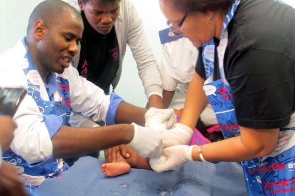 Surgery on a child with clubfoot.